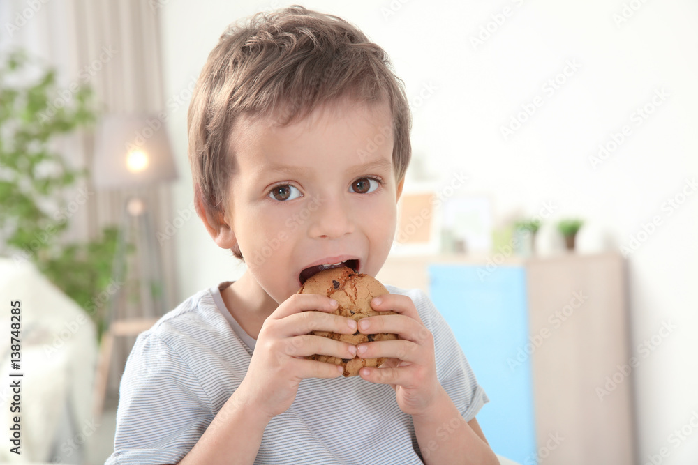 Cute boy eating cookie at home Cute boy eating cookie at home