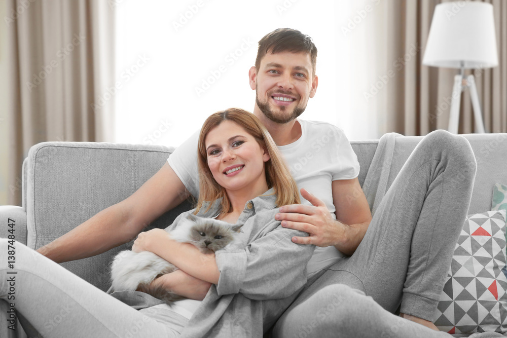 Happy couple with cat at home Happy couple with cat at home