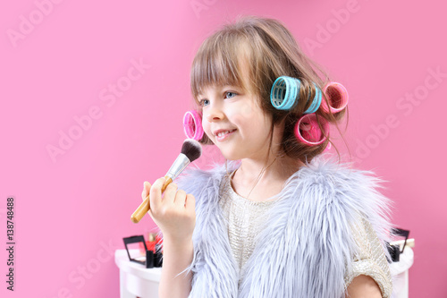 Cute little girl playing wi...