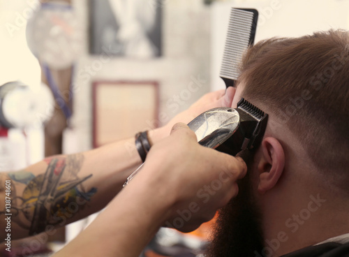 Barber making modern male hairstyle