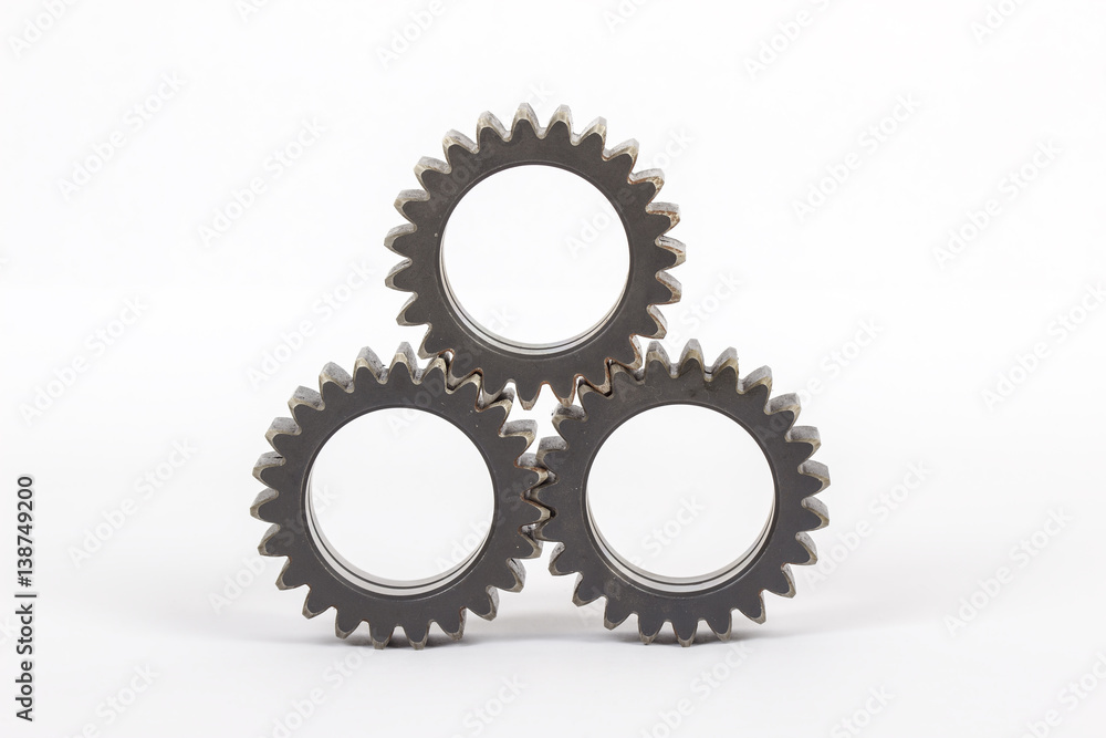 Small group of gears with their teeth engaged on a white background. Small group of gears with their teeth engaged on a white background.