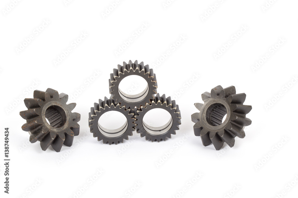 Small group of gears with their teeth engaged on a white background. Small group of gears with their teeth engaged on a white background.