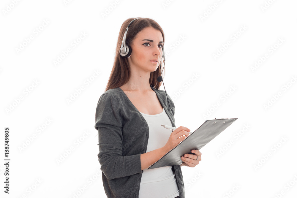 serious young girl stands sideways in headphones and holding a tablet serious young girl stands sideways in headphones and holding a tablet