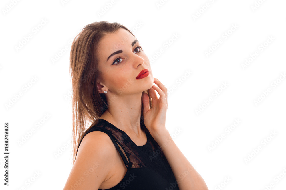 attractive young girl in black clothes is worth turning sideways and keeps a hand near the face attractive young girl in black clothes is worth turning sideways and keeps a hand near the face