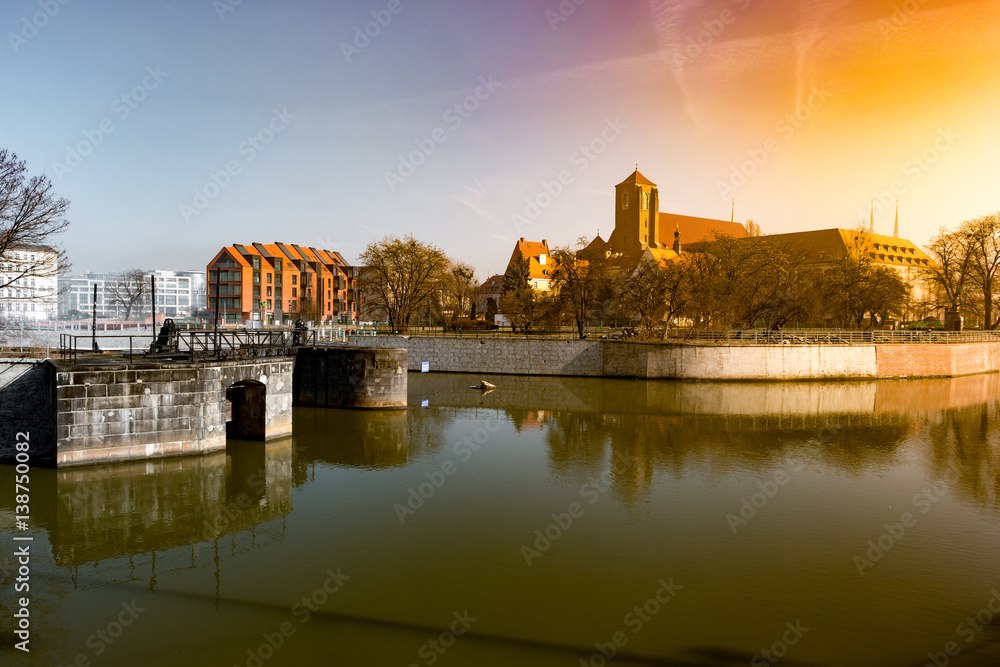 View on Church of the Holy Cross and St. Bartholomew, Odra river and Tumski Island, Wroclaw, Poland. Beautiful winter landscape.