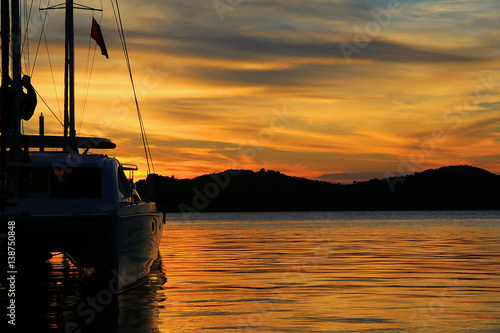 Yacht - Catamaran in the tropical sea at sunset. Yachting . Luxury Sailing theme.