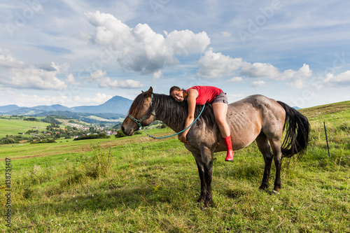 Girl with a horse on a field in Slovakian region Orava