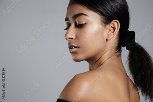 mixed race woman's portrait with ideal shining skin and healthy hair photo