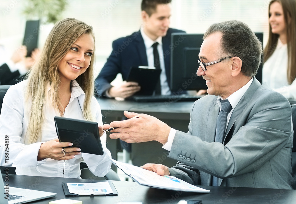 successful businessman and his assistant discuss the work plan successful businessman and his assistant discuss the work plan
