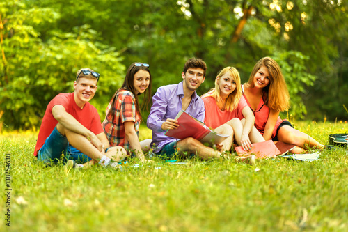 a group of students with notebooks in a Park on a Sunny day