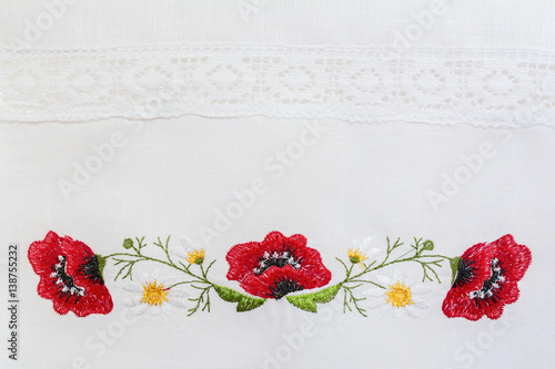 Embroidered floral pattern on a white linen towel photo