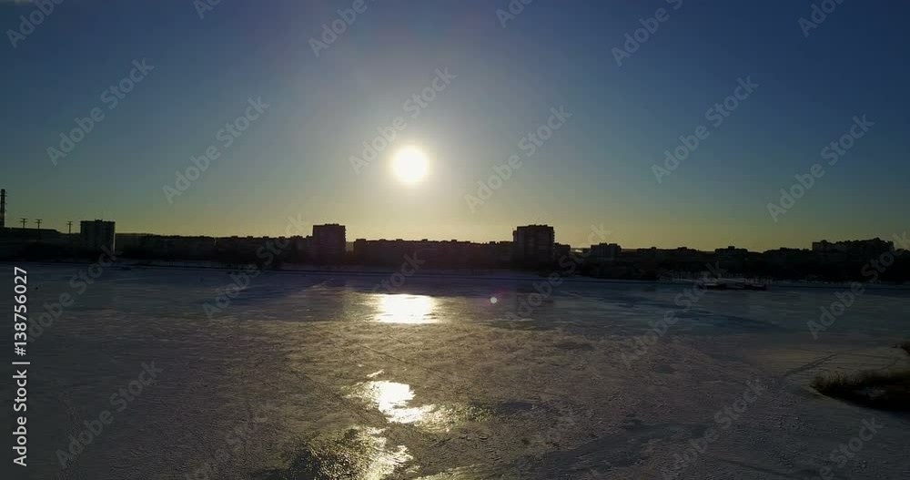 winter landscape by the river covered with ice
