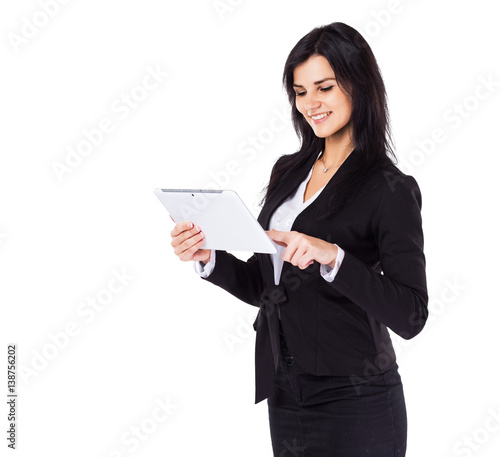 Young, attractive, successful business woman studying a business plan on the tablet