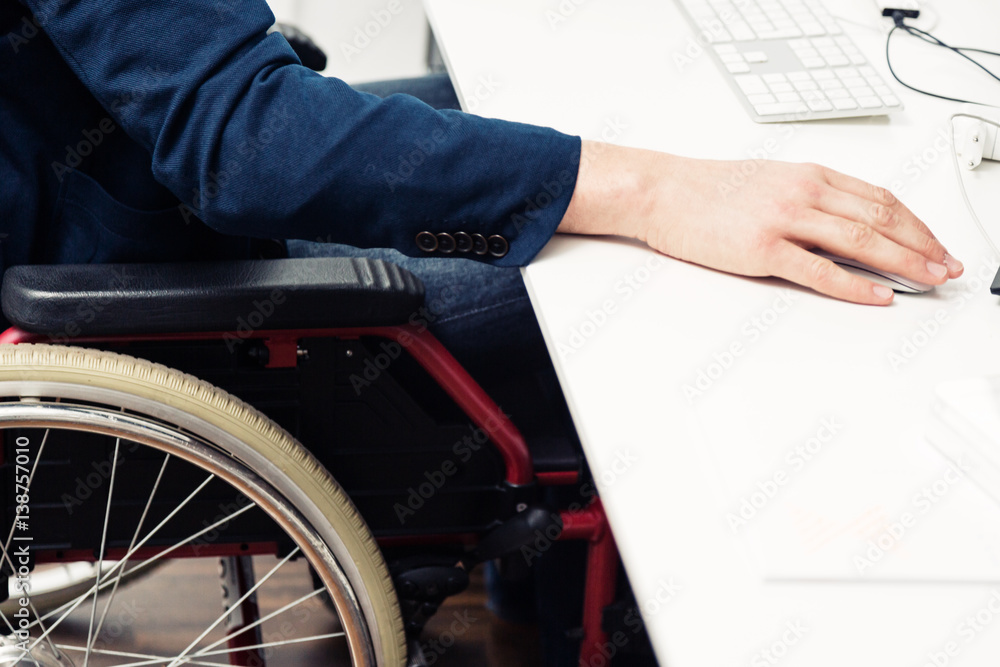 Man Sitting In Wheelchair Working In Modern Office