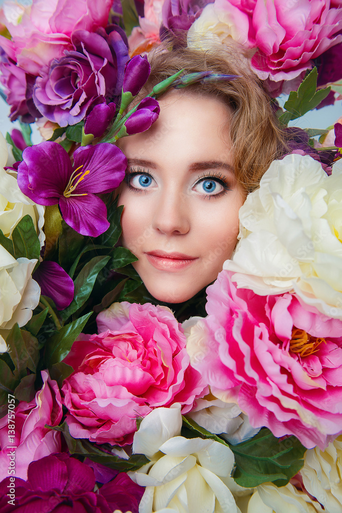 Portrait of smiling beautiful young girl in spring colorful flowers Portrait of smiling beautiful young girl in spring colorful flowers