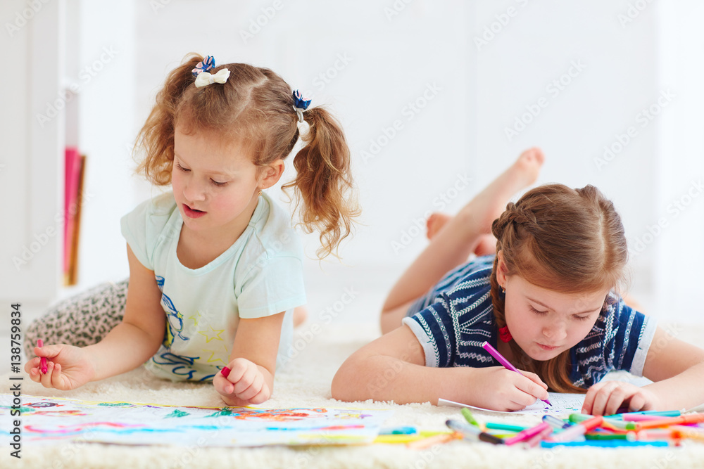 Fototapeta premium happy young girls, kids painting with felt pen together