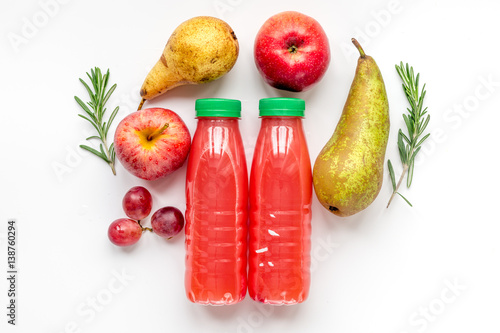 plastic bottles with fruit drinks on white background top view mock up