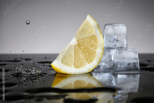 Lemon with water drop and ice cubes