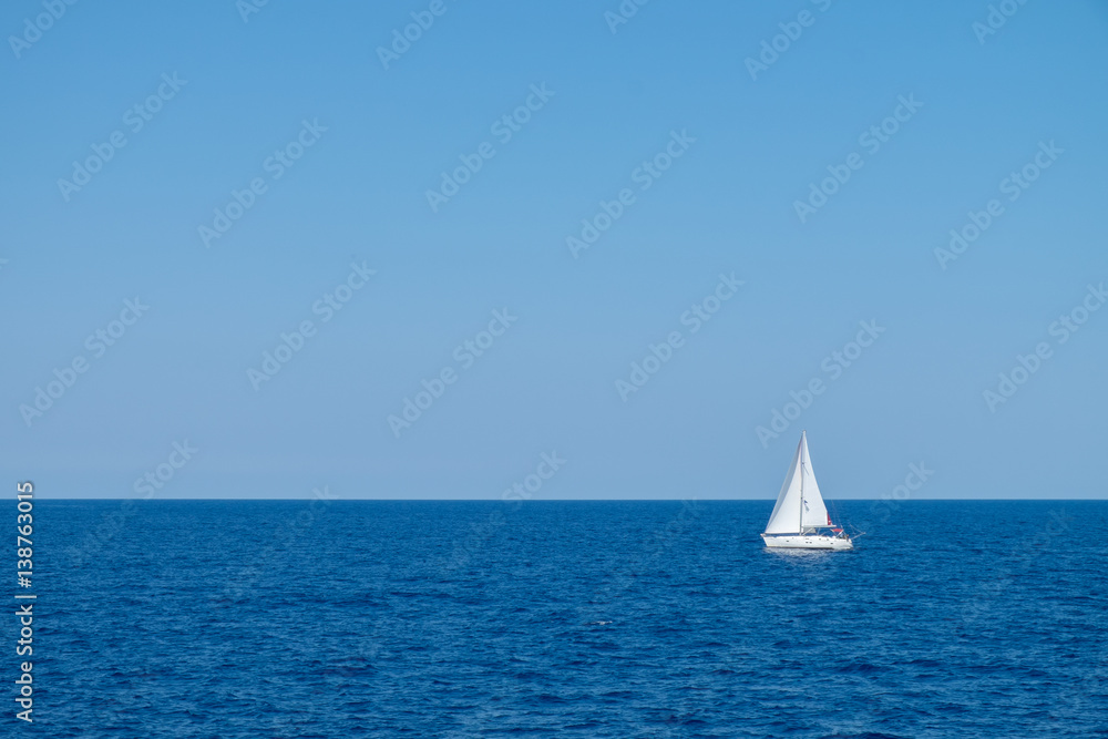 Boat sailing on the sea with clear blue sky