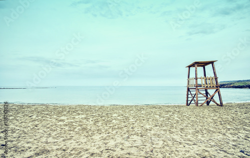 Empty sandy beach with lifeguard tower  Crete  Greece.