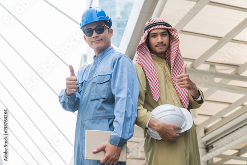 Arab businessmen and Smart foreman standing Thumbs up with in modern city
