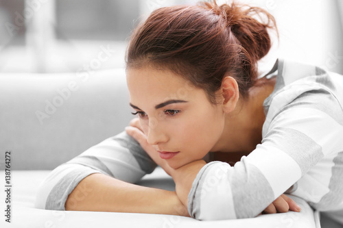 Depressed young woman at home, closeup