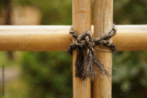 Rope tied on the bamboo fence close up shot