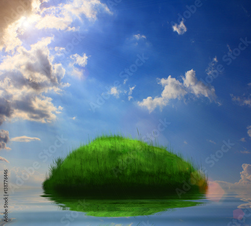 green island, covered in grass, in the middle of the ocean