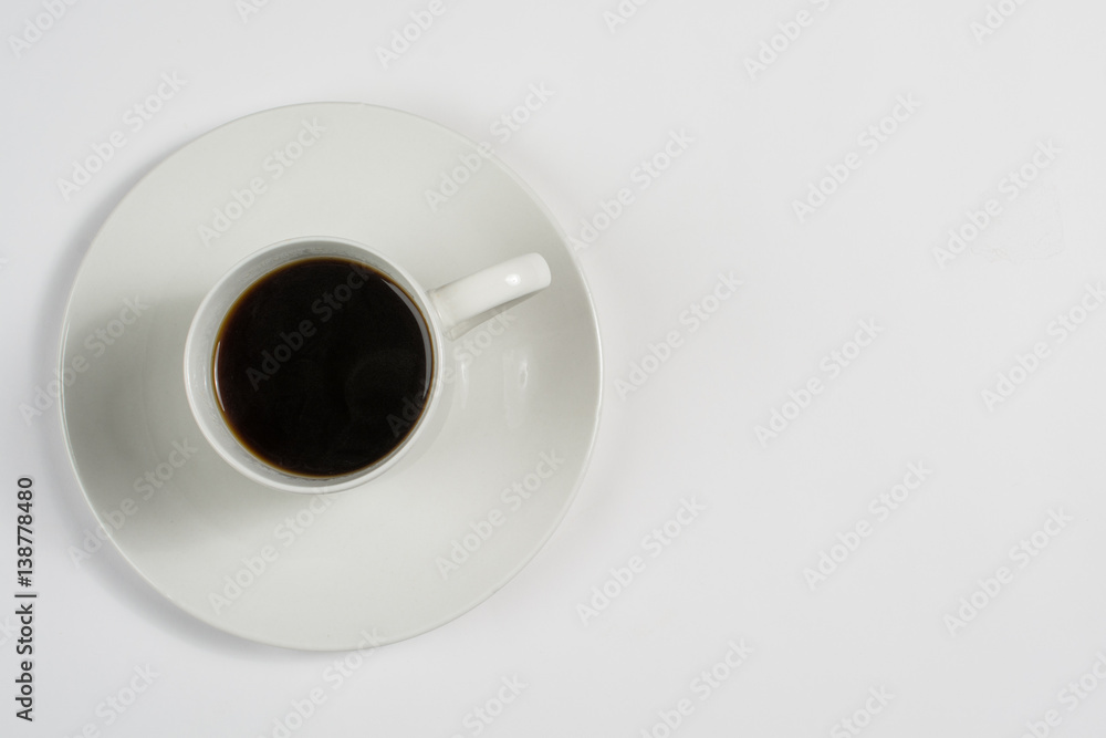 Top view of a white cup of coffee on white saucer Top view of a white cup of coffee on white saucer