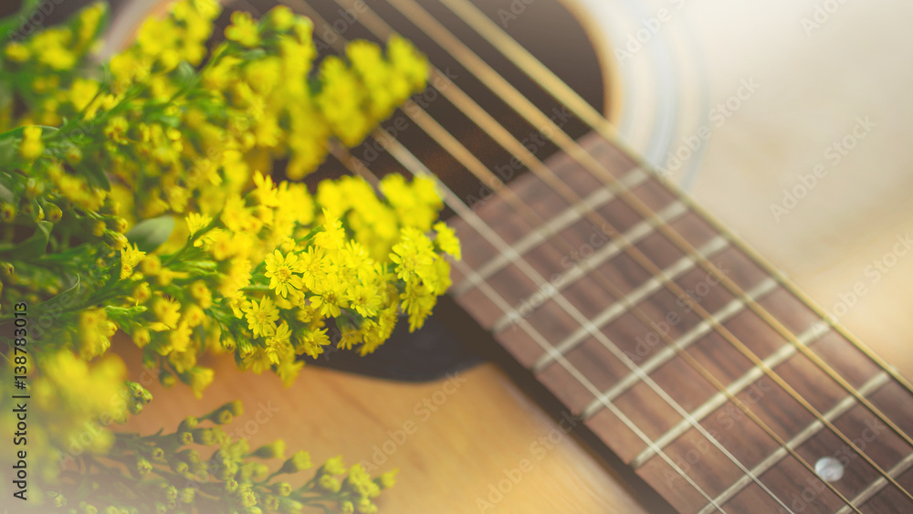 Obraz premium Morning relaxation and cozy with small yellow flower on guitar in vintage tone for Rural vacation lifestyle , music therapy concept