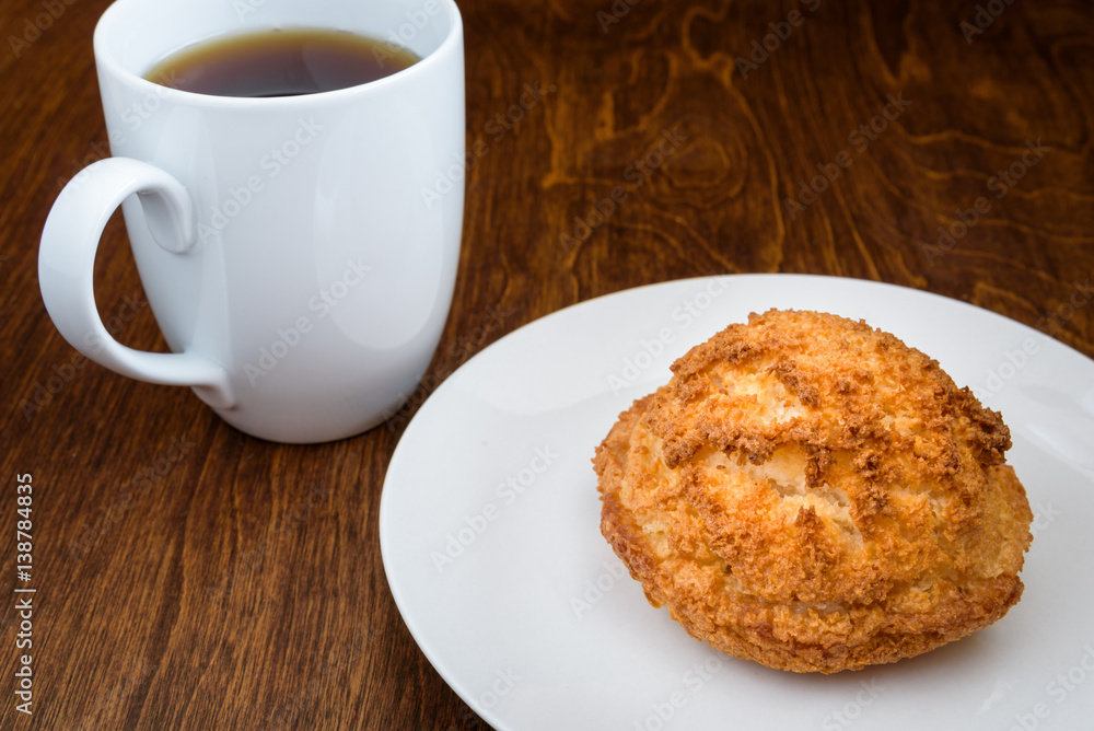 Homemade macaroon on a white plate, with a white coffee cup on a wood table
Homemade macaroon on a white plate, with a white coffee cup on a wood table