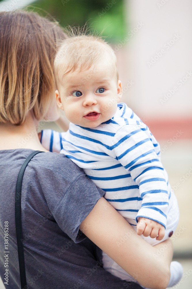 surprised child on hands of mothers surprised child on hands of mothers
