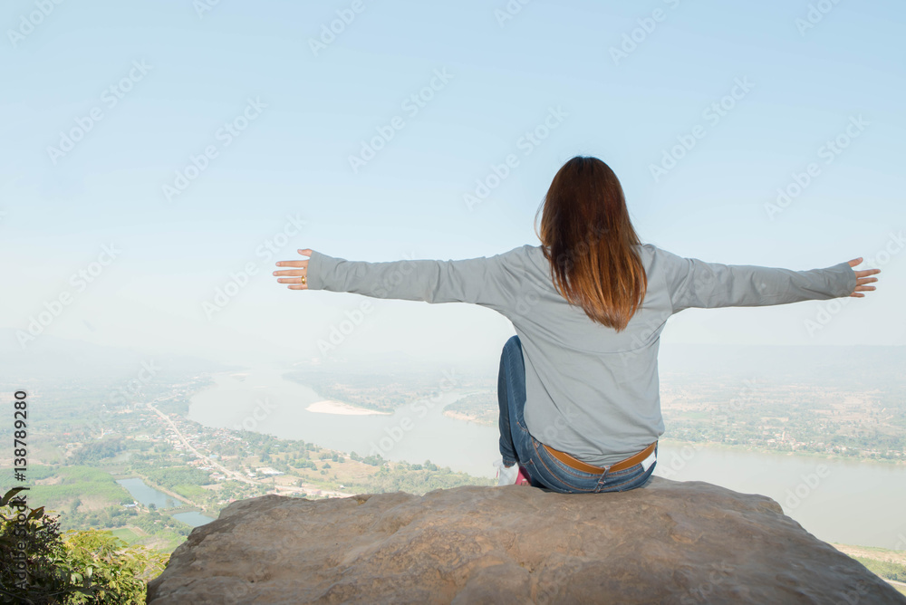 Young woman happy and relaxing in mountains with sunlight Young woman happy and relaxing in mountains with sunlight