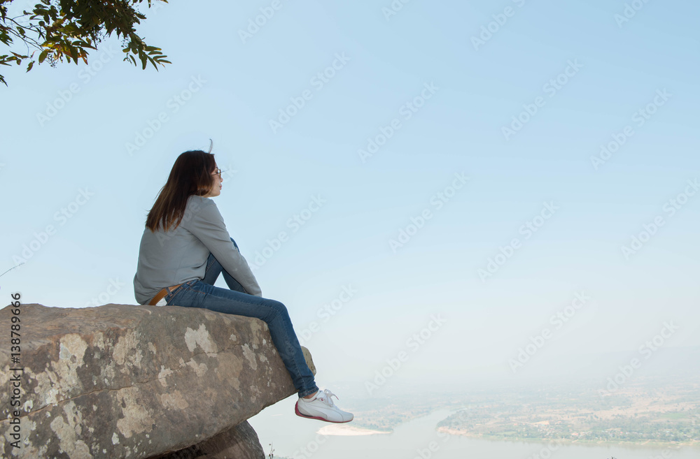Young woman happy and relaxing in mountains with sunlight Young woman happy and relaxing in mountains with sunlight