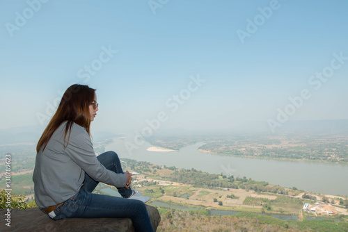 Young woman happy and relaxing in mountains with sunlight © patcharee11
