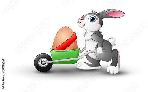 Easter bunny pushing a cart of easter eggs 