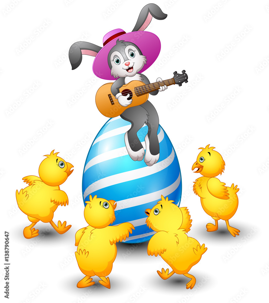 Cartoon rabbit playing guitar on a large egg is decorated and ...