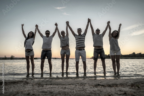 Silhouette of group young people on the beach.