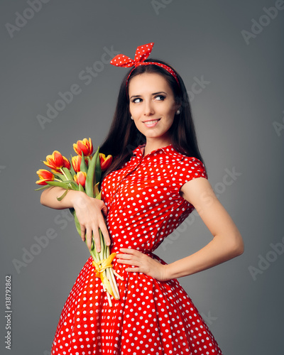 Schilderij op canvas Cute Girl in Retro Red Polka Dress with Tulips