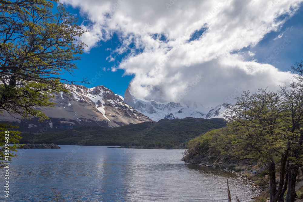 Landscape with the lake Capri in Patagonia with the view on Fitz Roy mountain covered with snow and clouds.