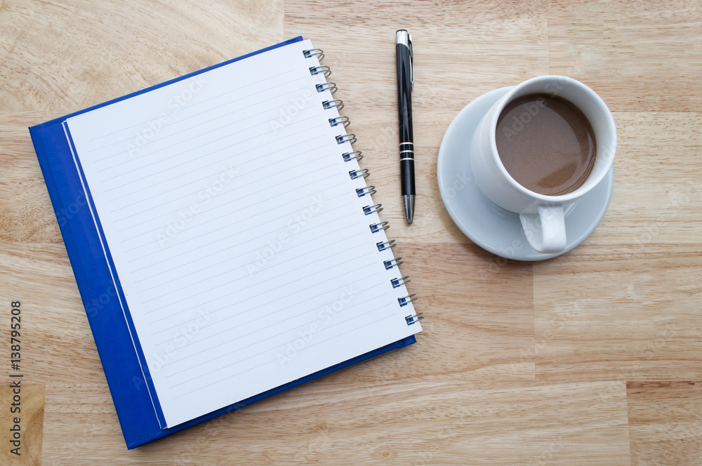 coffee with notebook on wooden table, view from above coffee with notebook on wooden table, view from above