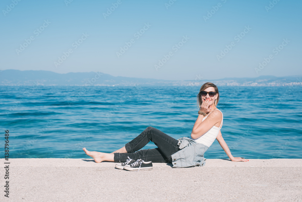 Young adult woman lying on beach