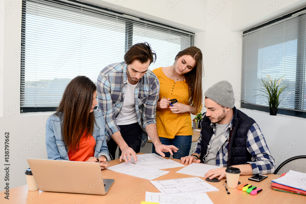 Obraz premium group of young cool hipster creative business people in casual wear working together in meeting room of a startup company
