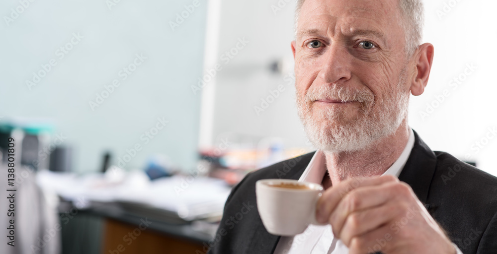 Portrait of smiling senior businessman with a cup of coffee Portrait of smiling senior businessman with a cup of coffee