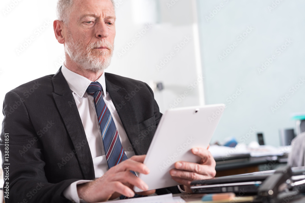 Portrait of senior businessman working on tablet Portrait of senior businessman working on tablet