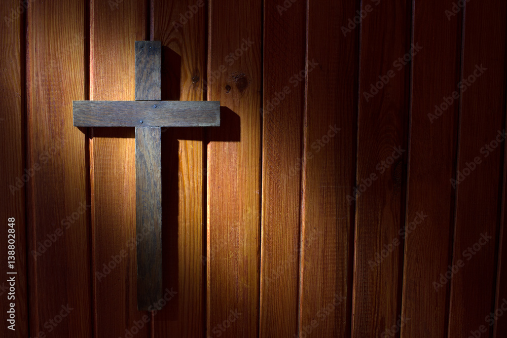 Cross on the wooden wall in night abstract easter background