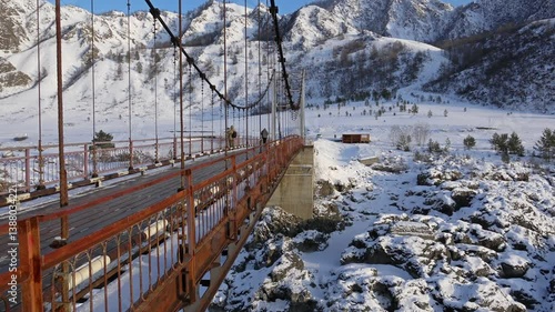 View on Katun river covered by ice and snow on Teldekpen rapids from Oroktoi bridge in winter season photo