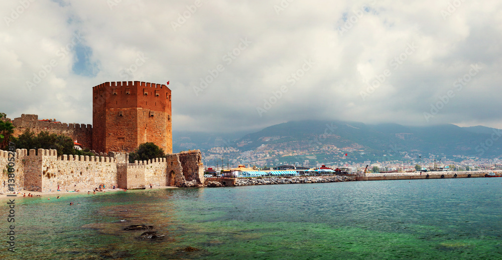 View of Red Tower (Kizil Kule) and ancient stone wall of Alanya Castle. Alanya, Turkey