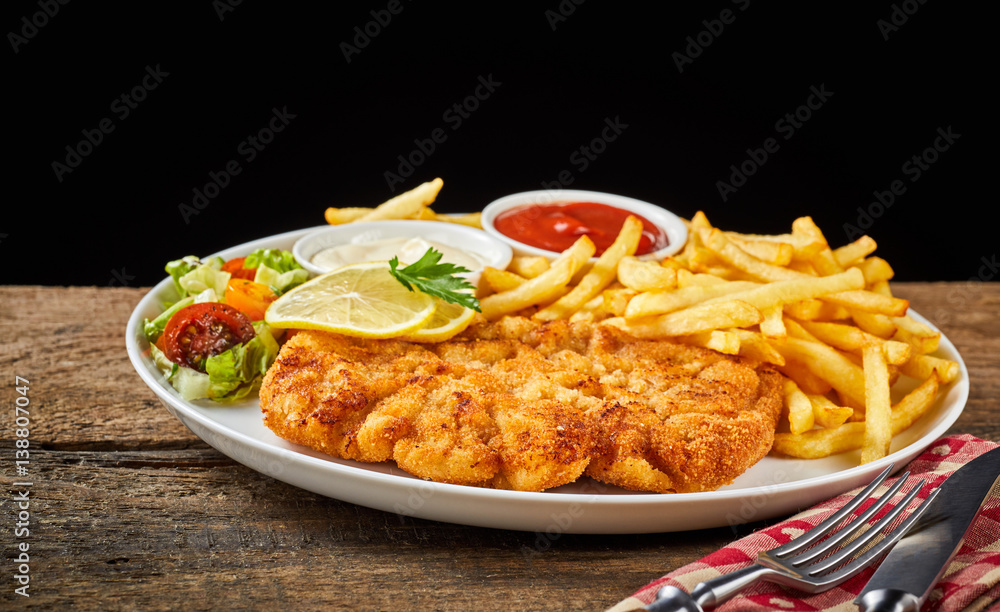 Dish of Wiener schnitzel and French fries Dish of Wiener schnitzel and French fries