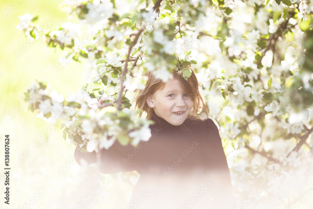 Pretty baby girl and spring flowers, childhood Pretty baby girl and spring flowers, childhood